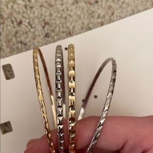 Four piece silver and gold bracelets